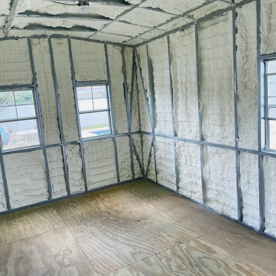 Closed-cell spray foam insulation applied to wall cavities in a residential project in Plainview